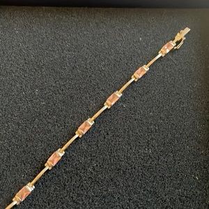 7 inch bracelet with pink stones. Silver plated in between stones.